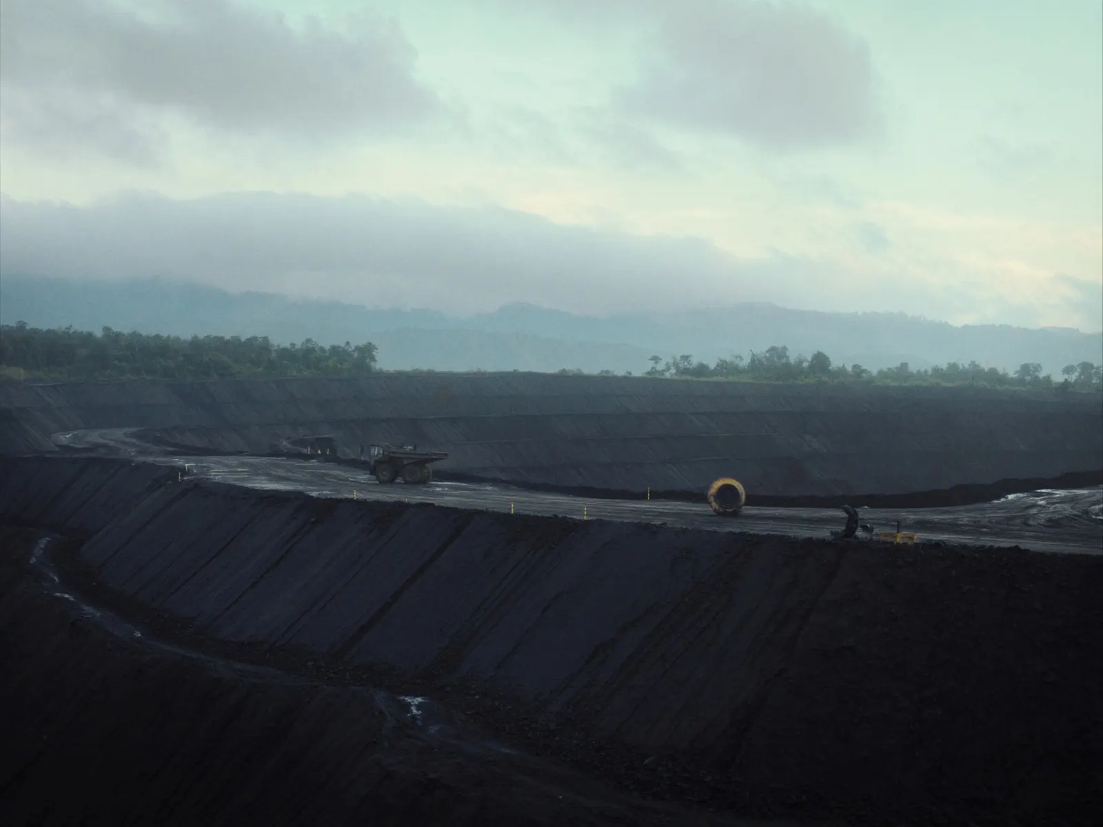 vast open-pit mine in East Kalimantan, Indonesia seen from the rim at dawn